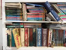 A shelf of classic automotive service manuals